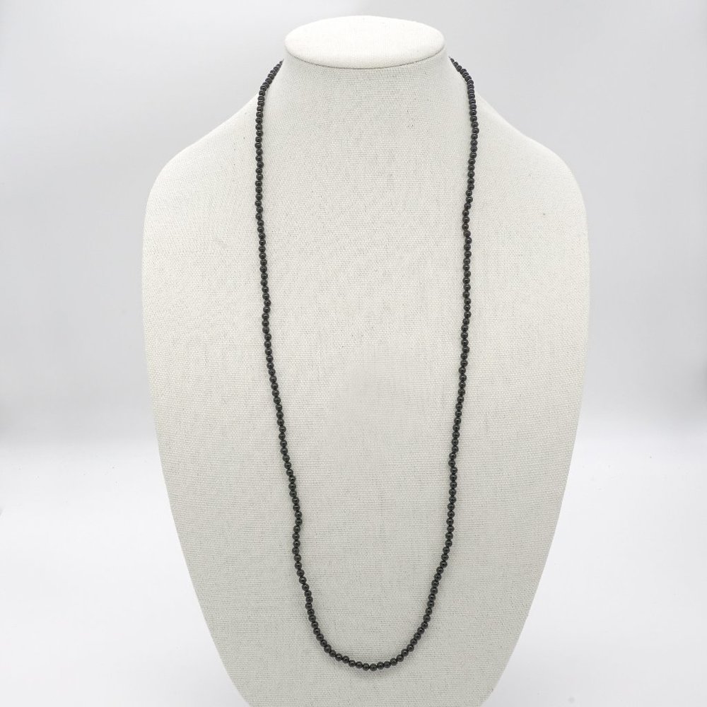 Long necklace with black acrylic beads.